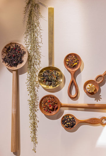 Several teaspoons holding Art of Tea's fall and holiday loose-leaf tea blends