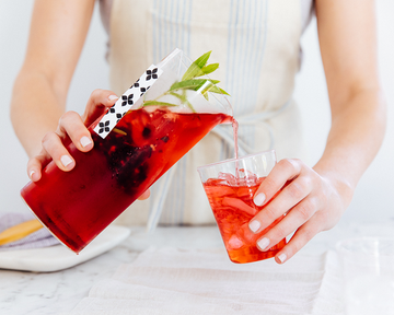 Pitcher of brewed iced tea being poured into a glass