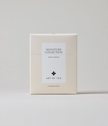 Tea box labeled 'Signature Collection' from 'Art of Tea' on a light gray background